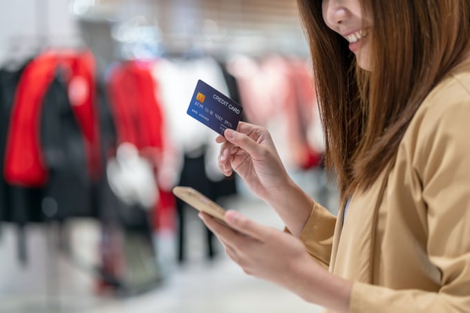 Browsing luxury goods or shopping in a high-end store, credit card in hand