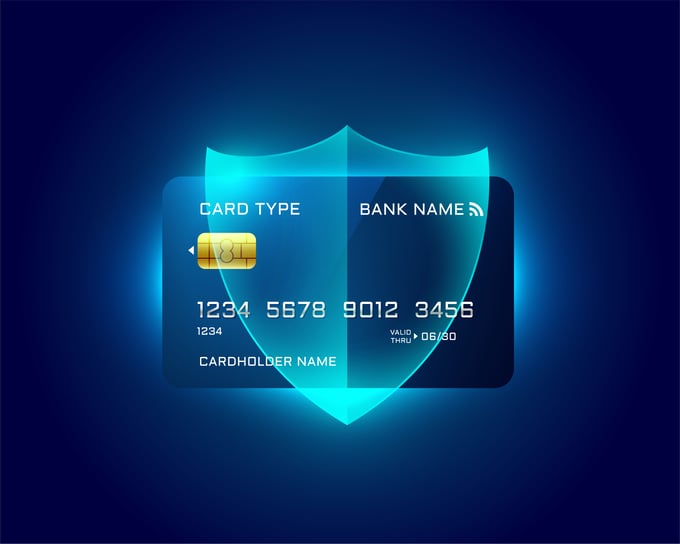 Credit card with shield hovering above it