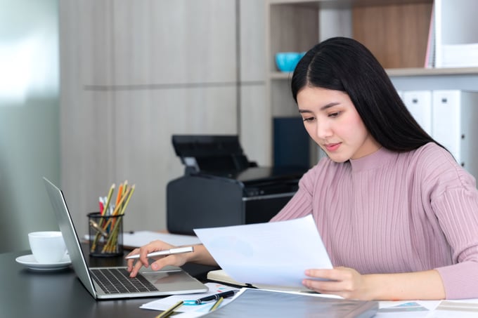 Person reviewing financial documents or a credit report on a laptop or tablet