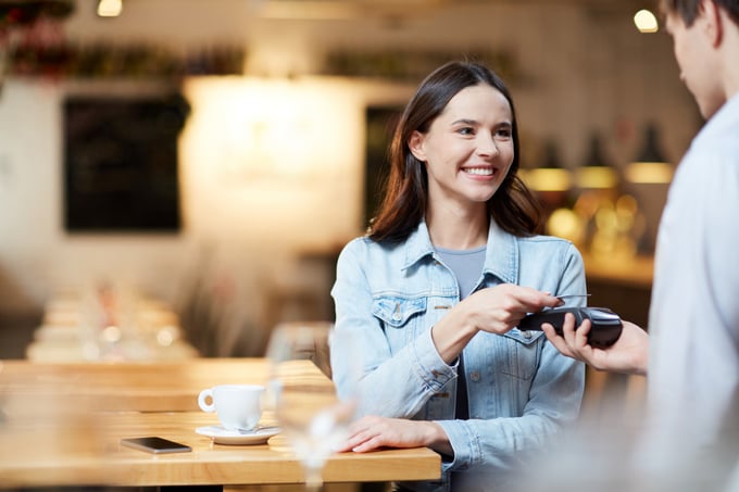 Young Adult Paying with a Credit Card in a Store